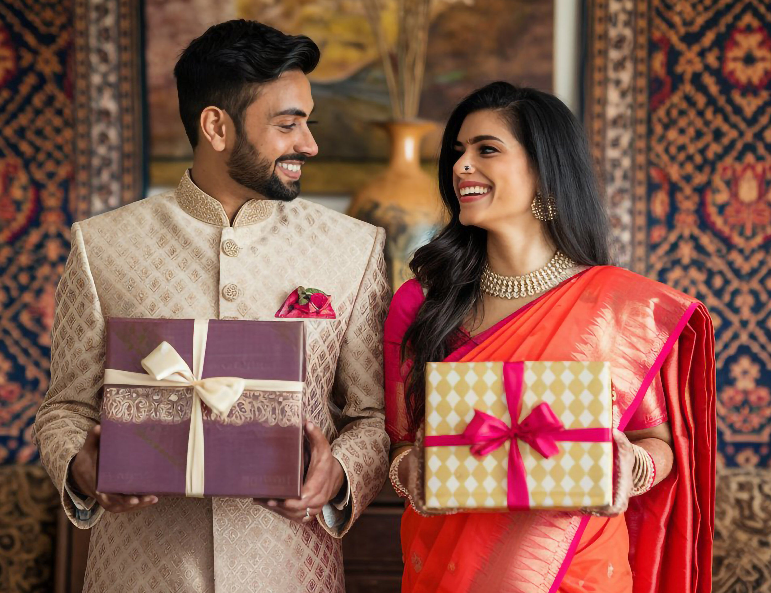 Bride and groom holding beautifull gift boxes